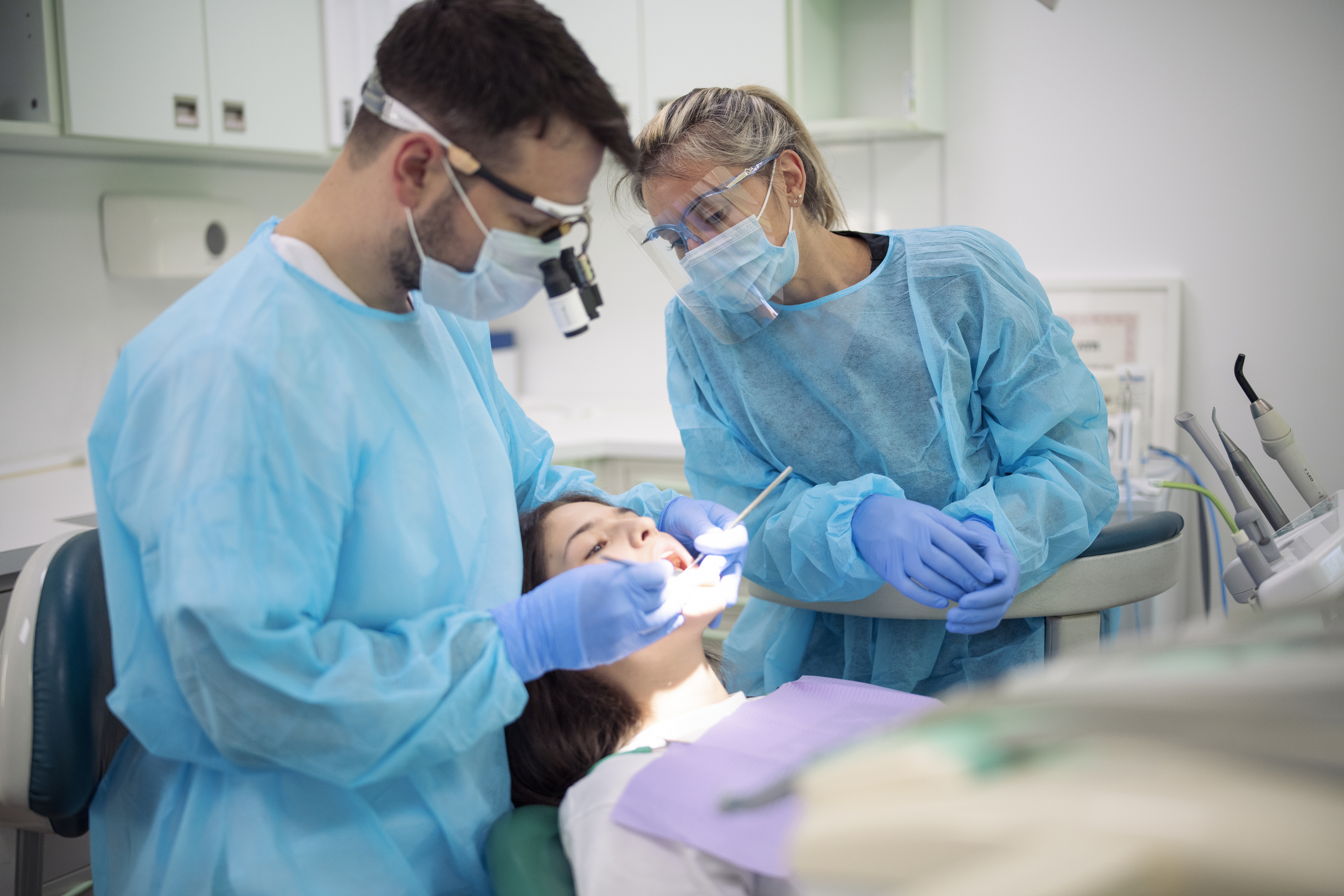 dentist-examining-patient-mouth-in-medical-clinic